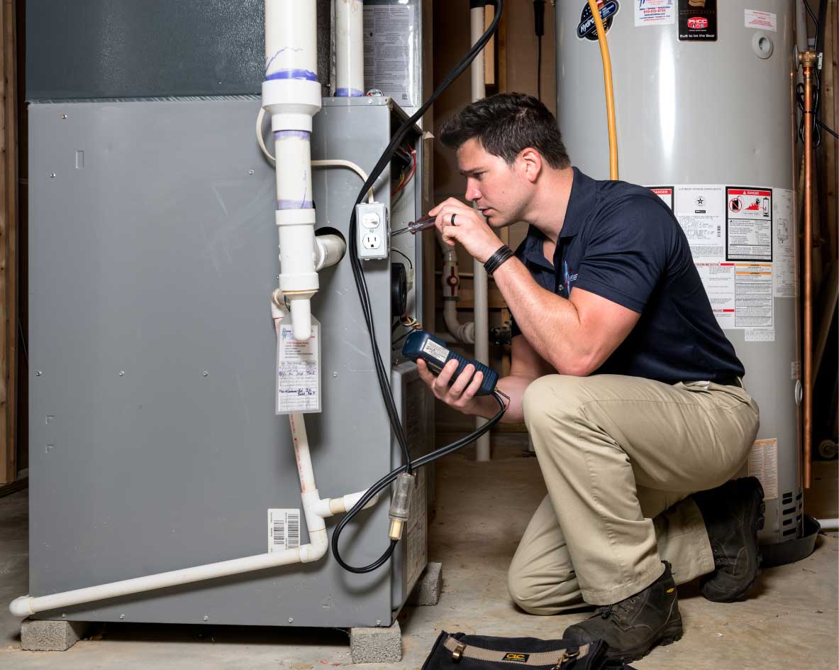 HVAC technician performing a furnace tune-up in American Fork