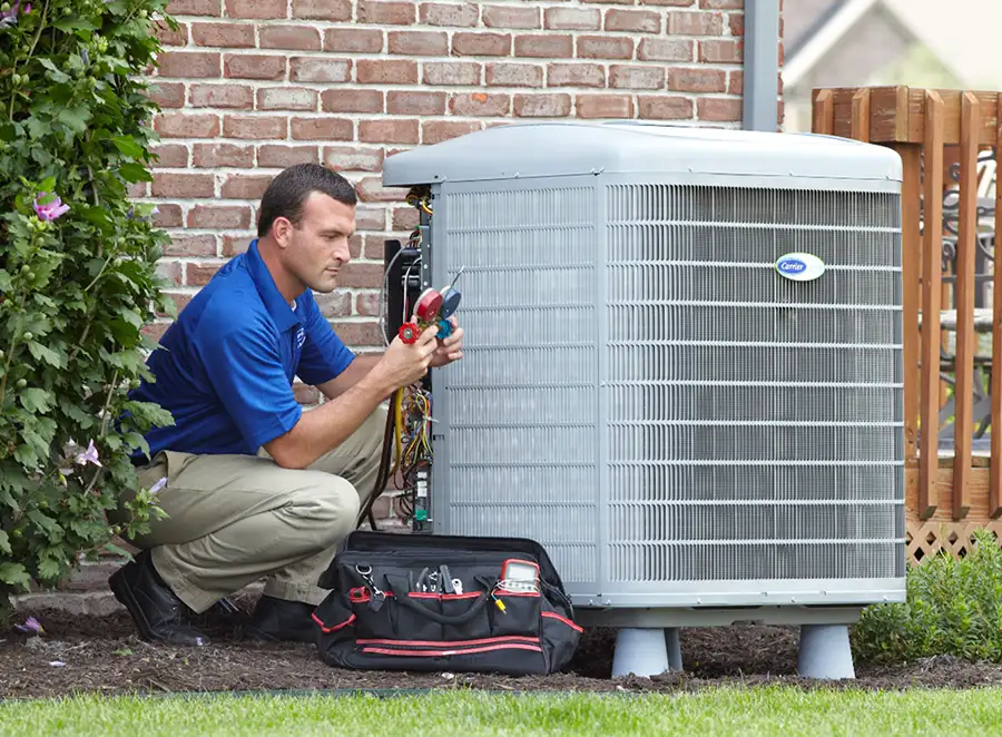 HVAC technician inspecting an outdoor air conditioning unit in American Fork