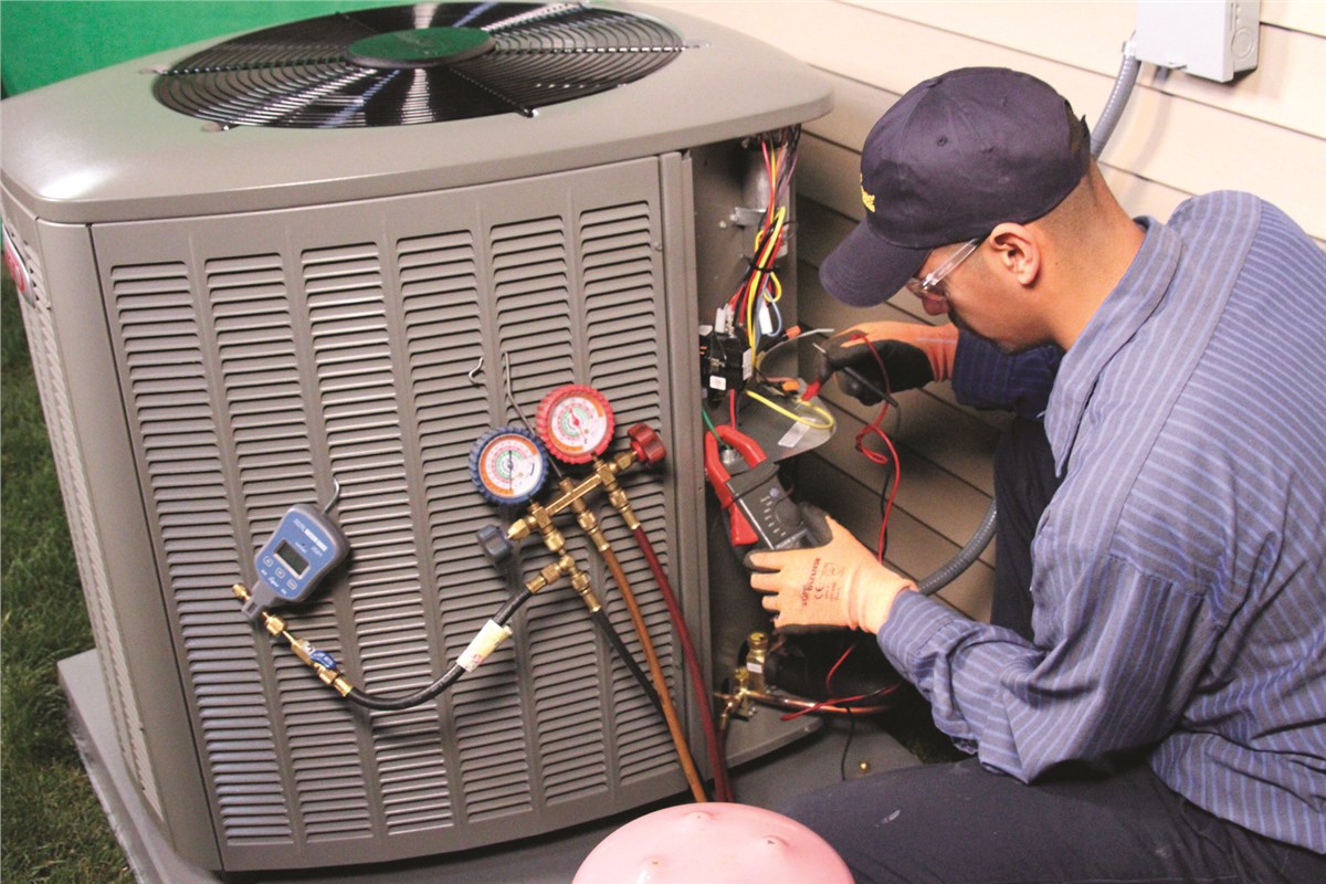 HVAC technician testing an outdoor air conditioning unit in American Fork