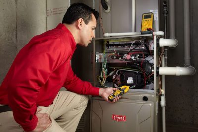 furnace repair Heating and air conditioning technician servicing an indoor furnace in American Fork, UT
